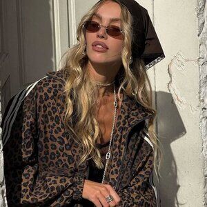 Miu Miu MUA54S 26C09Z Sunglasses Old Gold Oval Frame, Dark Brown Lenses